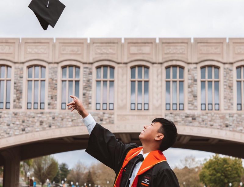 A graduate smiles during a commencement ceremony in lane stadium