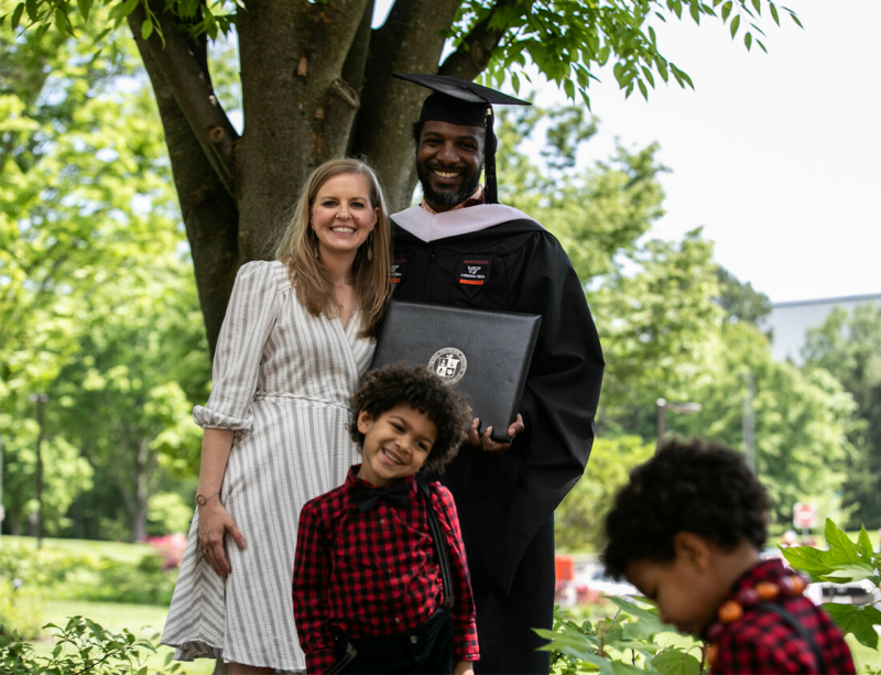 A graduate smiles during a commencement ceremony in lane stadium