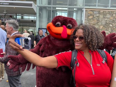 woman taking a selfie with HokieBird