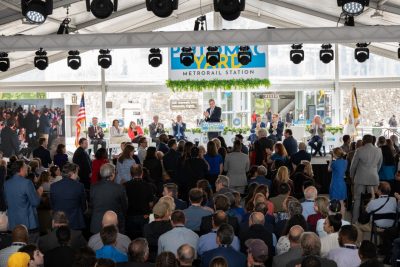 man speaks in front of a crowd