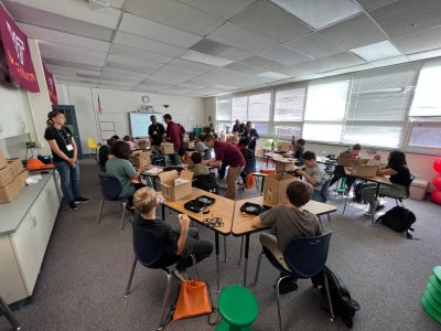 classroom of students building drones