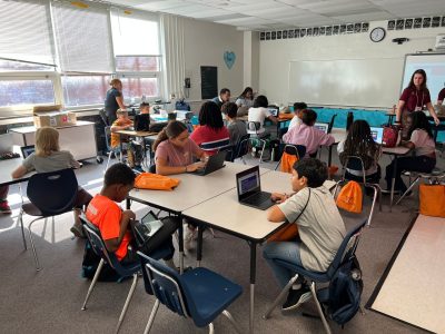 classroom of students work on computers