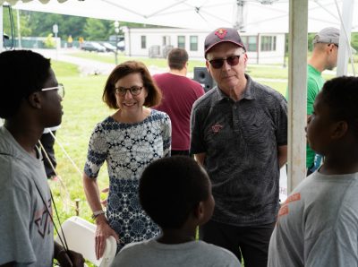President Tim Sands, Laura Sands, and students