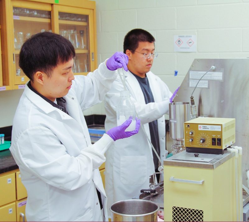 Sustainable Biomaterlals students Kihyeon Ahn (left) and Chenxi Cao use a homogenizer to collect cellulose nanofiber.