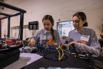 two students building a drone